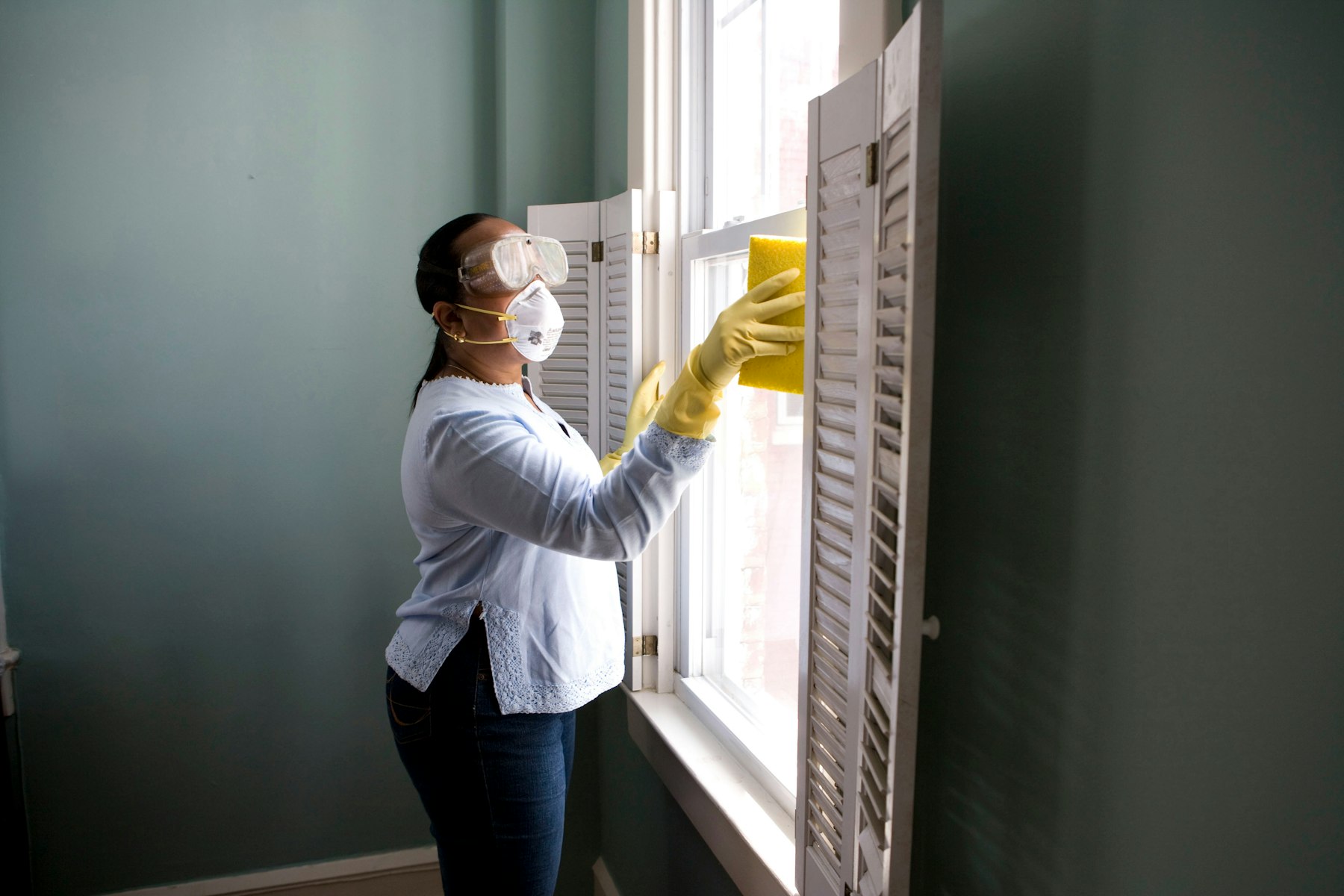 Person cleaning a window ahead of a property handover