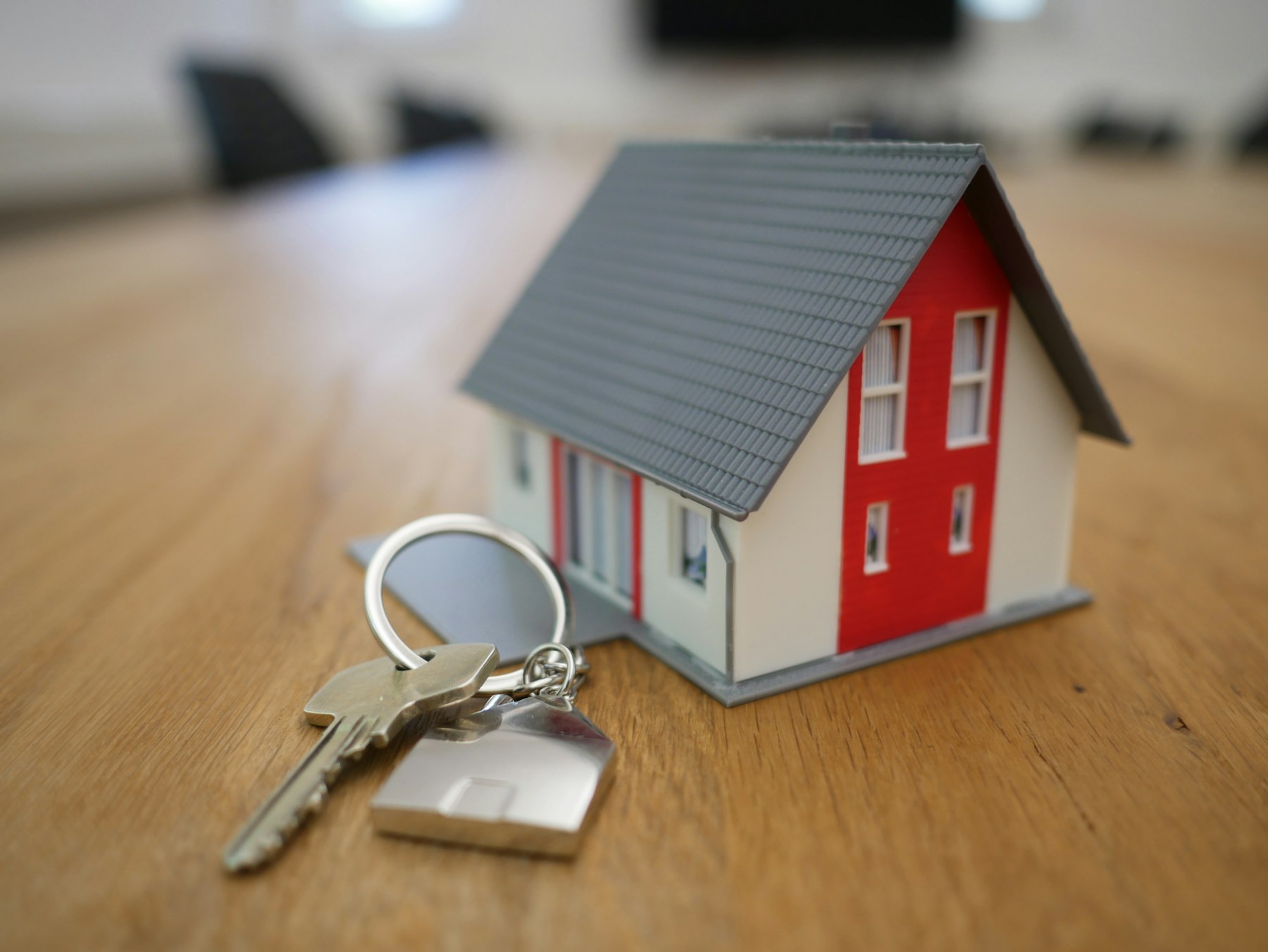 House keys beside a small model home